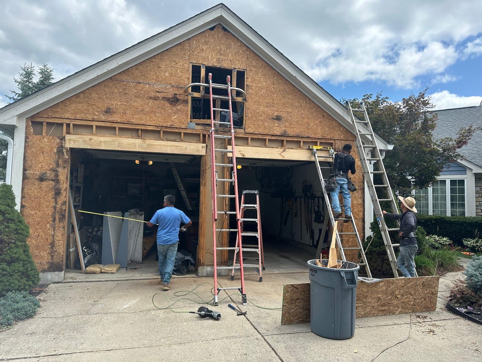 Crew on scaffolding installing siding wrap